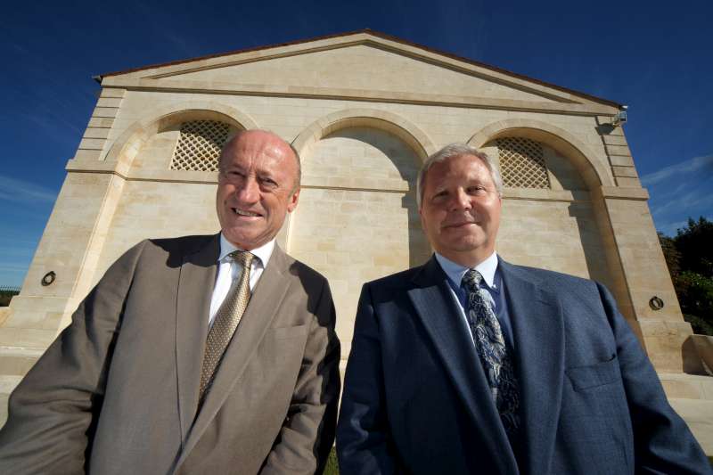 The two pillars of Mouton Rothschild, Herve Berland and Philippe Dhalluin, stand in front of the main building, in a powerful and authoritative pose, depicting the character of the wine.